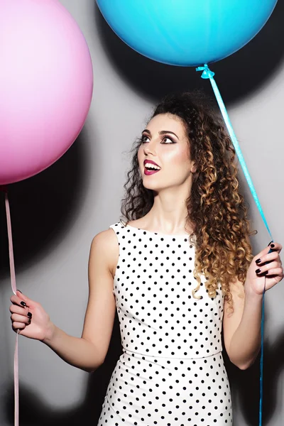 Smiling young beautiful girl with balloons — Stock Photo, Image