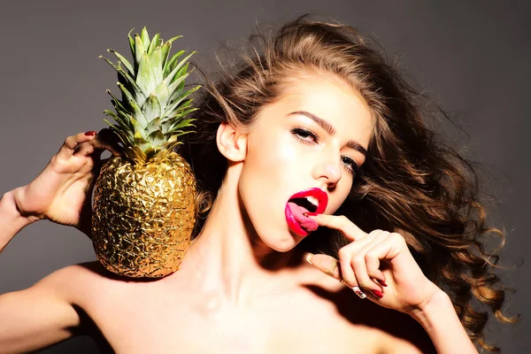 Sensual young girl with golden pineapple — Stock Photo, Image