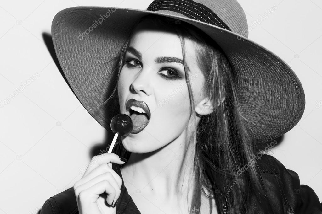 Wild young blonde woman black and white portrait with sugar candy 