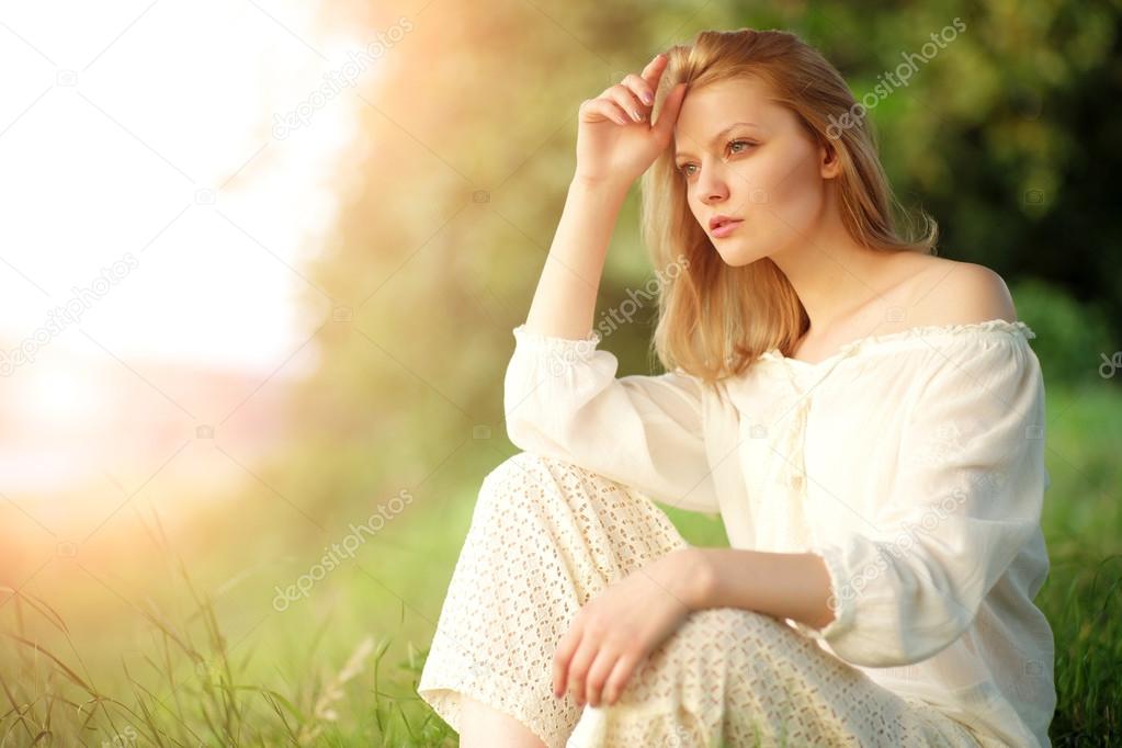 Young lady in sunset near river