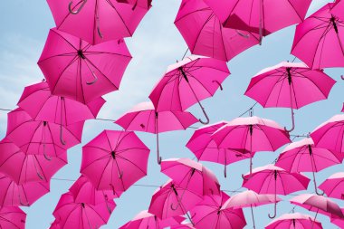 Pink umbrellas in the air