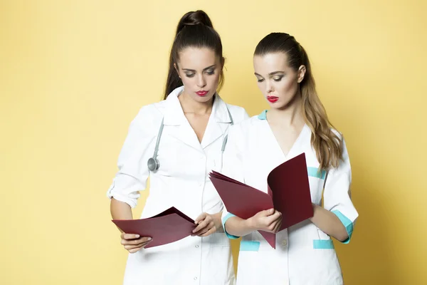 Beautiful doctor and nurse with file — 图库照片
