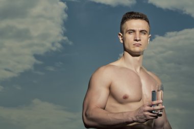 Attractive bodybuilder with glass of water