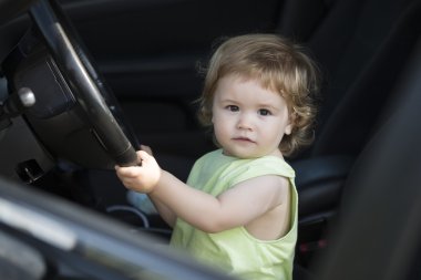 Little male driver in car