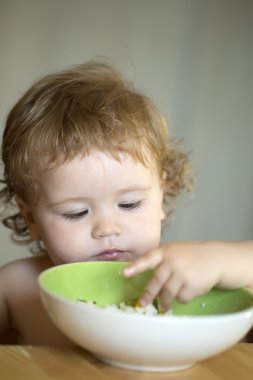Portrait of small male kid eating