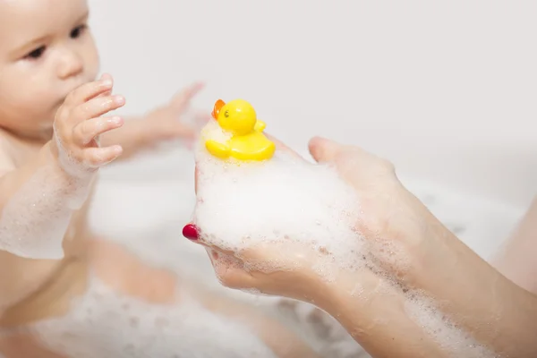 Little kid with duck in bathroom — Stock Photo, Image