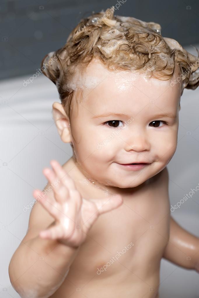 Smiling baby with lathered hair in tub Stock Photo by ©  78033468