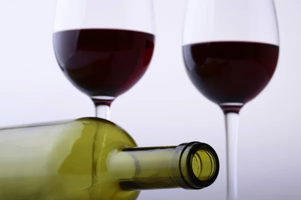 Empty lying bottle and glasses with red wine — Stock Photo, Image