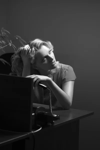 Tired female secretary with phone — Stock Photo, Image