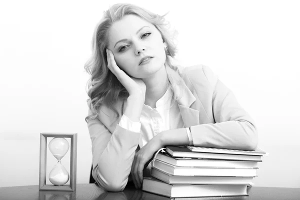 Tired woman with books and glass — Stock fotografie