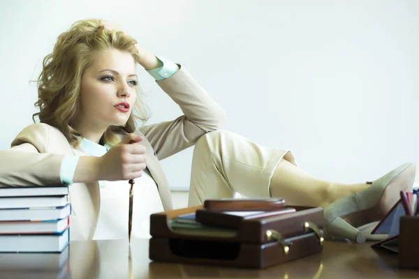 Thoughtful woman with paper knife in office — 스톡 사진