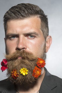 Man with flowerbed on beard