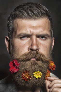 Man with flowerbed on face