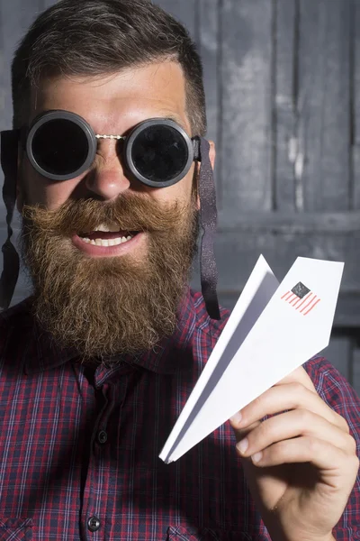 Man in glasses and paper plane — Zdjęcie stockowe