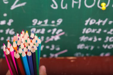 Colorful pencils and school blackboard
