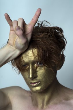 Golden man with cool gesture