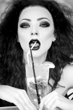 Erotic woman drinking mojito