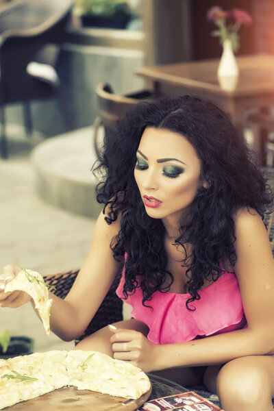 Sexy woman eating pizza