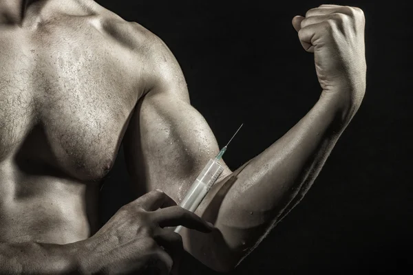 Male biceps and syringe — Stock Photo, Image