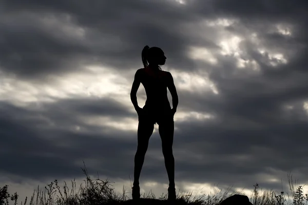 Female silhouette on sky background — Stock Photo, Image