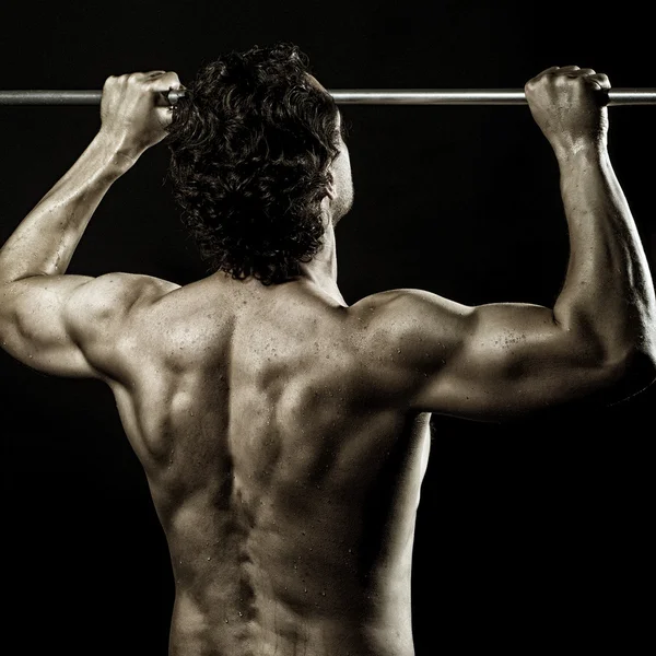 Handsome man doing chin-ups — Stock Photo, Image