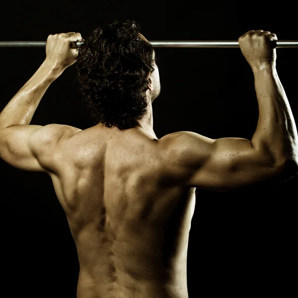 Attractive man doing chin-ups — Stock Photo, Image