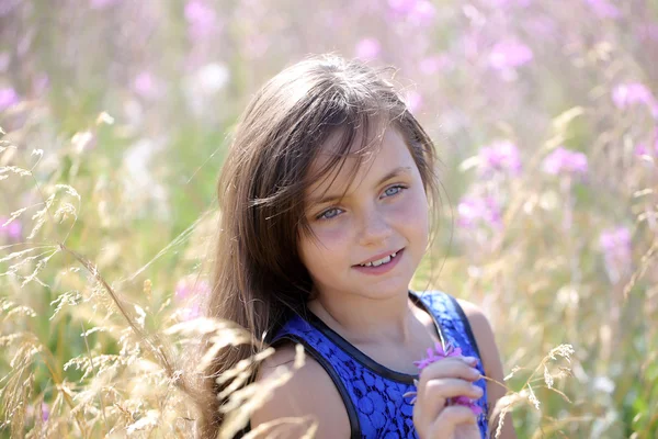 Pretty girl among flowers — Stock Photo, Image