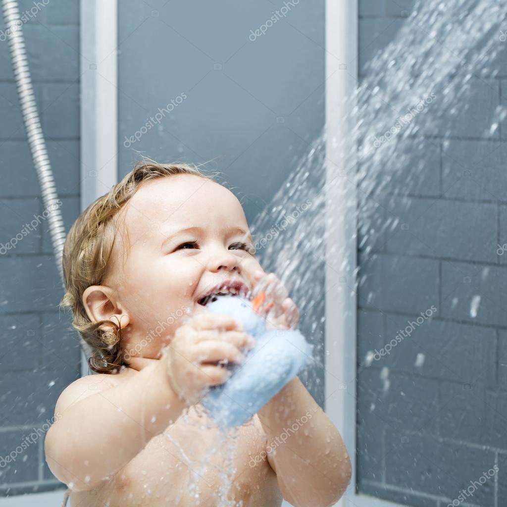 Smiling child in shower — Stock Photo © 84289706