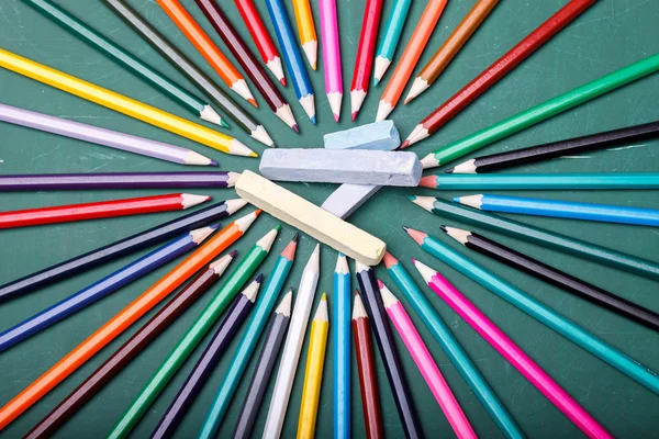 Pencils around chalk — Stock Photo, Image