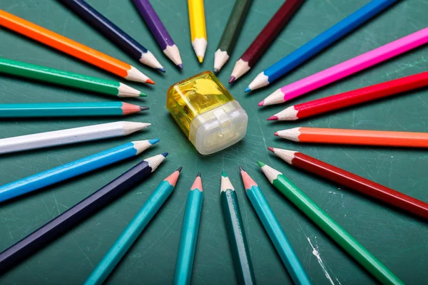 Pencils around sharpener — Stock Photo, Image