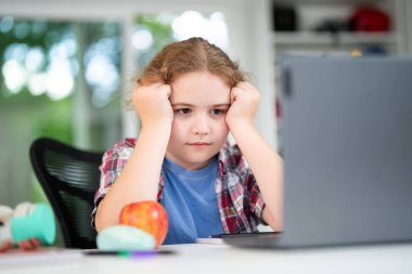 Child on online school lesson at home. Kid learning on laptop e-learning. Teen student learn lesson on laptop. Teenager study remotely using laptop. Teen student doing homework during online lesson
