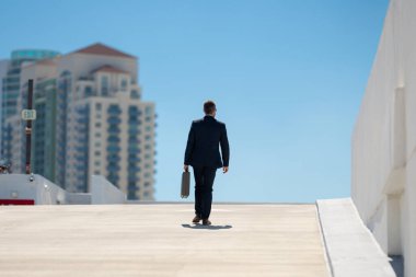 Evrak çantasıyla yürüyen bir iş adamı. İşadamı çekip gidiyor. Şirket lideri git buradan. Çantalı takım elbiseli adam. Profesyonel bir iş adamı. Kentsel iş adamı