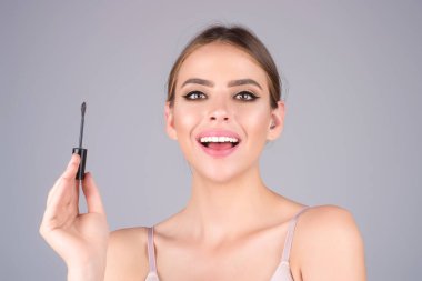 Eyebrow makeup. Beauty model shaping brows with brow pencil closeup. Womans eyebrows with eyebrow brush. Natural make up. Modeling brows. Comb eyebrows