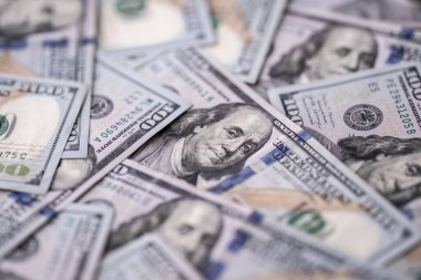 Money background with 100-dollar bills. Texture of US money currency. 100 USD banknotes in focus. American hundred-dollar money for banner. Pattern of US dollars. Money for finance concept