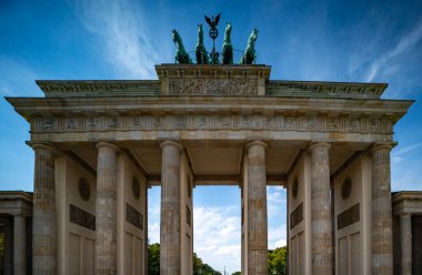 Tarih Brandenburg kapısı, Berlin 'de, mavi gökyüzünün altında. Berlin 'in ünlü Brandenburg kapısı barışın sembolü. Berlins dönüm noktası. Berlin Almanya 'da mimarlık. Berlin kapısının arkasında gökyüzü parlıyor.