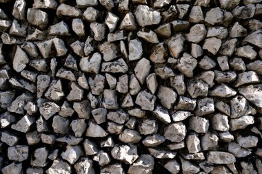 Stone wall texture. Detailed stone surface in rustic wall. Textured rock wall pattern up close. Natural stone blocks with rough texture. Stone masonry wall