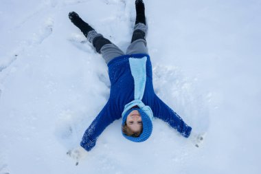 Kar meleği yapan bir çocuk. Karlı melek kanatlarıyla karda yatan mutlu çocuk. Karda kaygısız bir çocuk. Noel tebrik kartı ile evlen. Kış tatili macerasında komik çocuk. Çocuklarla kış yolculuğu