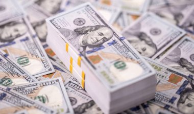 Stack of dollars and cash with a money background. US dollars money and banknotes. Pile of 100 USD bills. American hundred-dollar notes. Pattern of money. Cash and credit theme. Money dollars