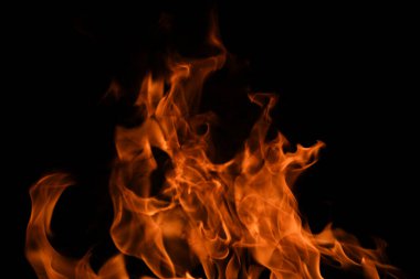 Siyah arka planda yangın alevleri. Ateş, izole edilmiş, soyut bir yapı. Yanan ateşle yanan patlama efekti