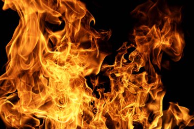 Alev deseni. Arkaplanda alevler var. Siyah arka planda parlayan alevler. Alevlerin cehennem etkisi. Alevli ateş. Alev soyut tasarım. Şiddetli yangın arkaplanı