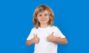 Child showing thumbs up on studio isolated background. Portrait of kid boy making thumbs up sign