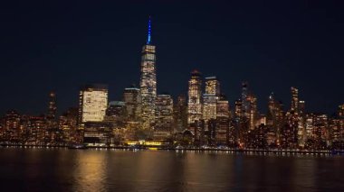 Hudson Nehri üzerindeki New York silueti. İkonik kuleleri olan New York Manhattan silueti. Geceleri New York şehri panoraması. NYC Amerikan şehrinin silueti gece ışığında. New York Manhattan gökdelenleri