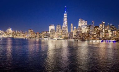 Geceleri New York 'ta. New York Skyline gece görüşü. New York şehir deniz manzarası. Manhattan gece görüşü. New York panoramik. New York şehir manzarası. New York gece silueti. New York Şehri 'nin Manhattan hava manzarası