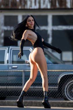 Sexy Back, Ass. Woman Posing Sexy Outdoor near Garage Wall. Beautiful Slim Woman Body. Firm Buttocks. Perfect Female Booty Body. Sexy Shape of Buttocks. Sensual Portrait of a Beautiful Sensual Woman