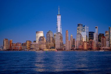 Manhattan cityscape over waterfront. NYC skyline scenic river view. New York City skyline iconic panorama. Manhattan skyline photography scene. NYC skyline modern American city