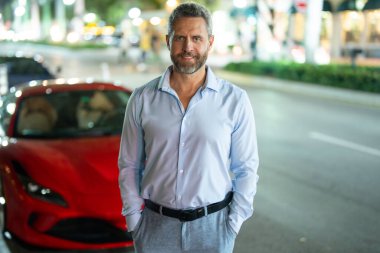 Man handsome middle aged walking city street. Man standing casual jeans urban lifestyle. Man looking confident during summer travel. Man enjoying weekend holiday journey