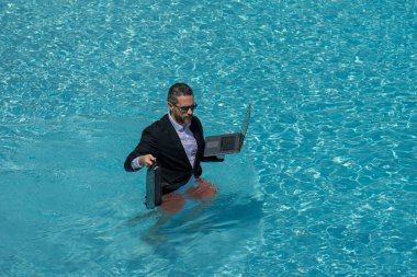 Takım elbiseli çılgın iş adamı havuzda dinleniyor. Bilardoda çalışan çılgın bir serbest yazar. Deniz sahilinde dizüstü bilgisayarı olan komik bir iş adamı. Seyahat ve sahilden hoşlanan bir adam. Yaratıcı çevrimiçi strateji