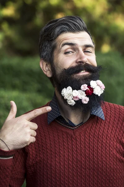 Mies, jolla on kukkia parrassa — kuvapankkivalokuva