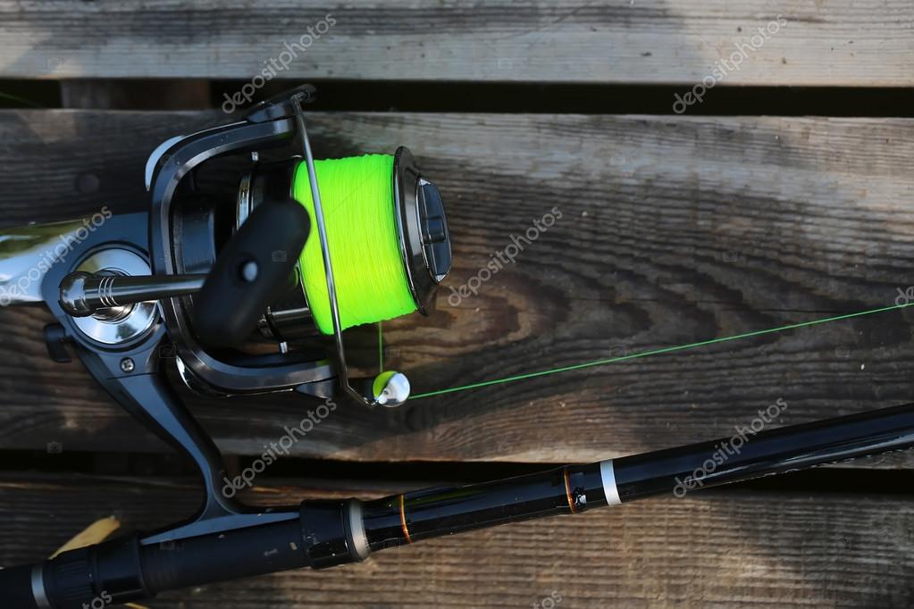 Fishing spinning rod and reel — Stock Photo © Tverdohlib.com #87524326