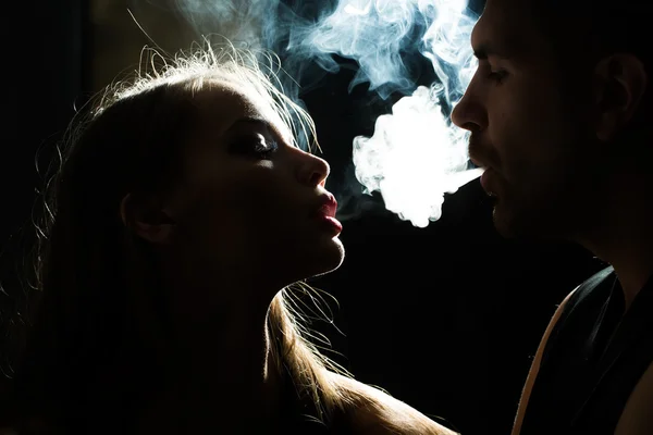 Paar pustet Rauch ins Gesicht — Stockfoto